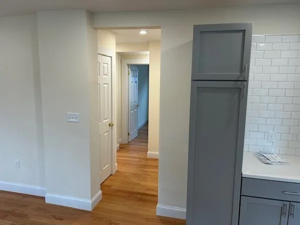 a view of a hallway with wooden floor