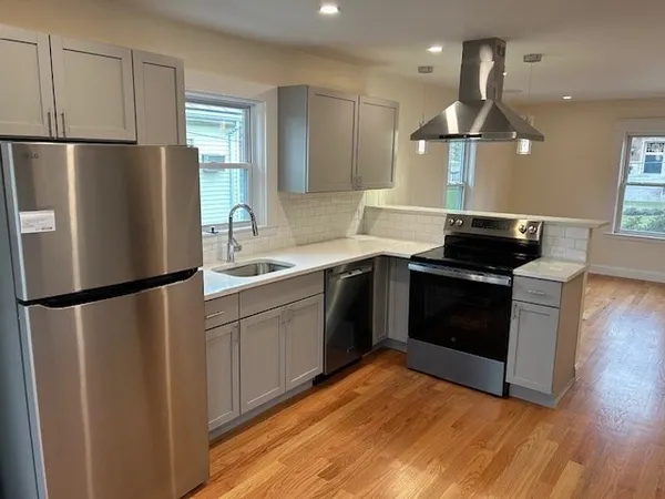 a kitchen with a refrigerator sink and cabinets