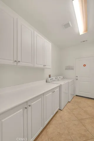 a view of a kitchen with white cabinets