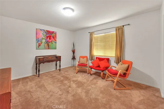 a living room with furniture a air conditioner vent and a window