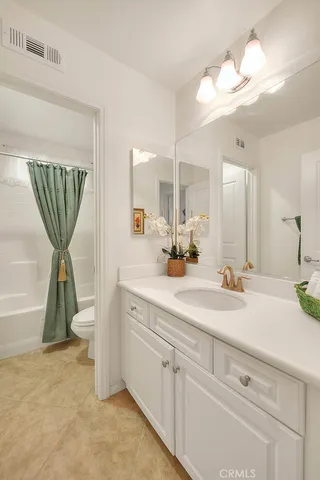 a spacious bathroom with a sink a mirror and vanity