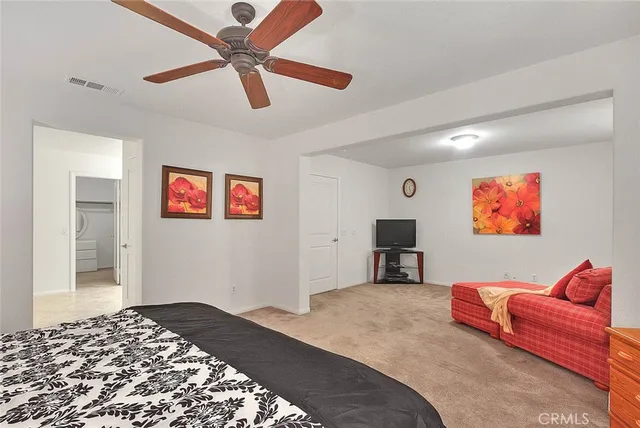 a bedroom with a bed and a couch