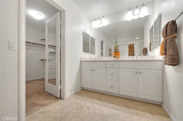 a bathroom with a double vanity sink and mirror