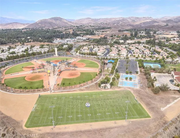 an aerial view of residential houses with outdoor space and ocean view