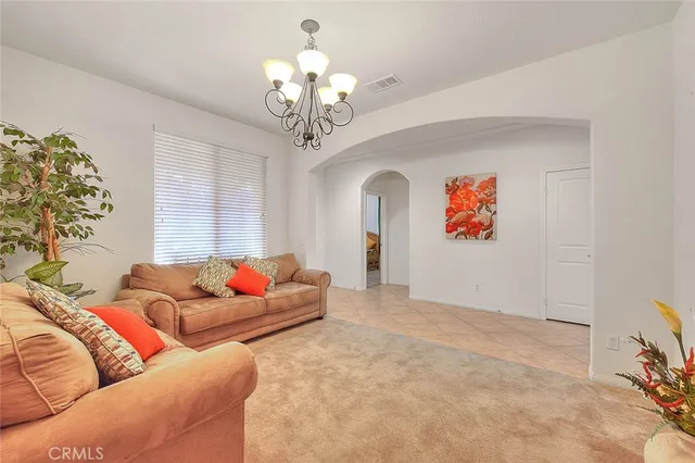 a living room with furniture and a chandelier