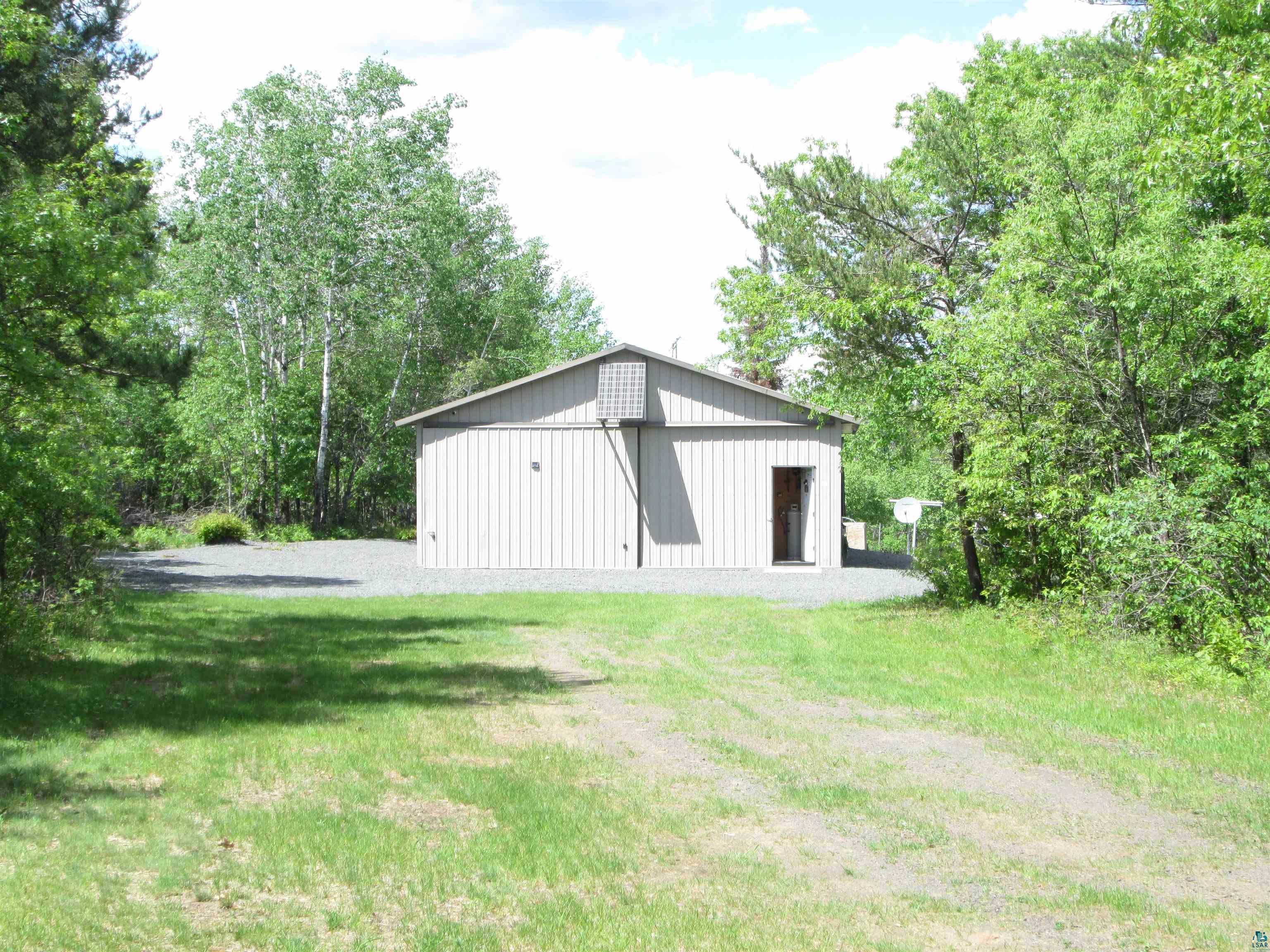 11521 Cheney Lake Road Solon Springs, WI 54873 - Photo 1 of 26 View of yard with a garage and an outdoor structure