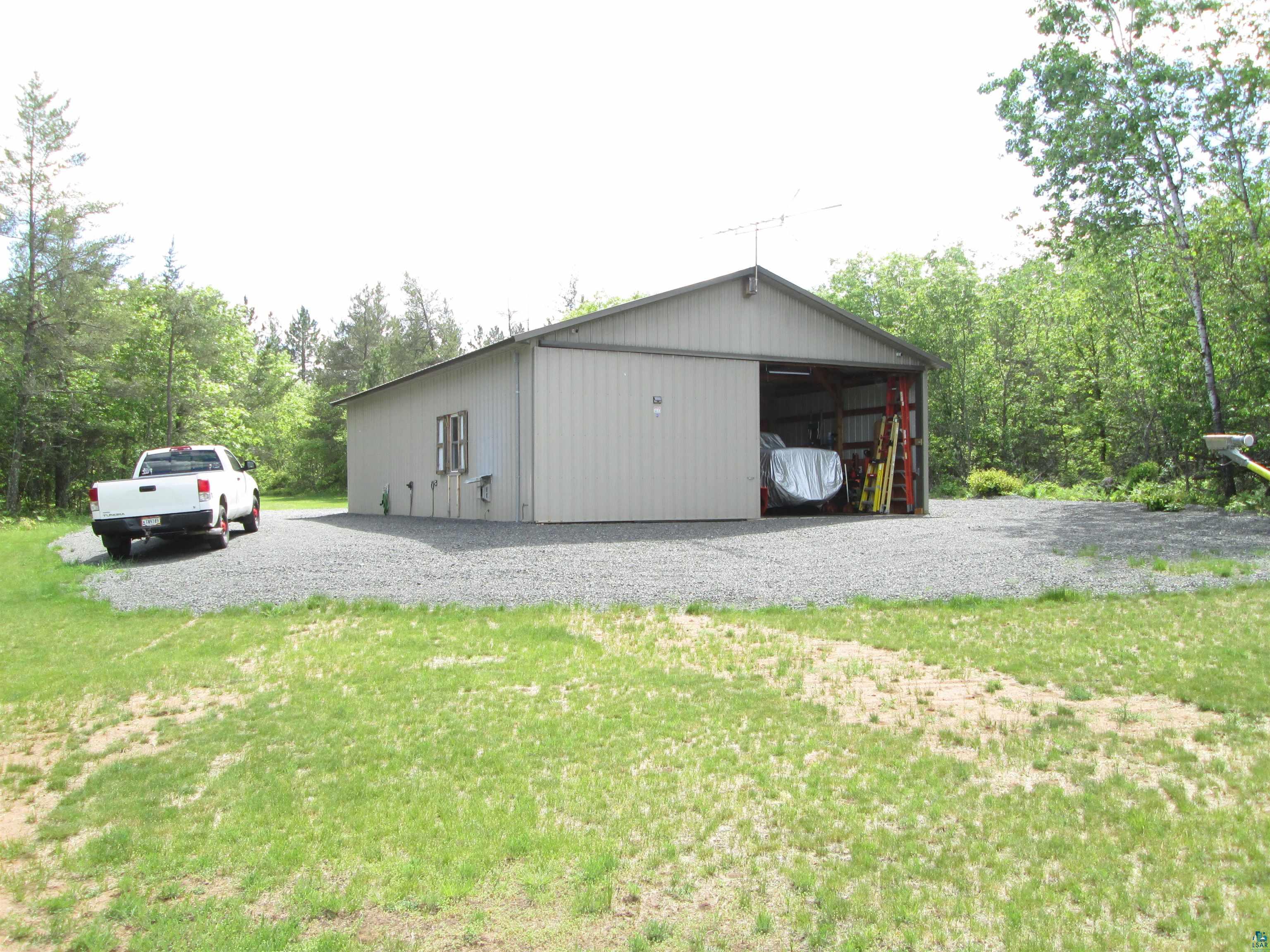 11521 Cheney Lake Road Solon Springs, WI 54873 - Photo 4 of 26 View of outdoor structure with a garage and a lawn