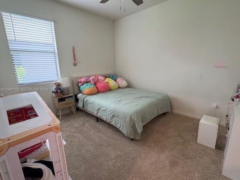 571 Old Country Rd S East Palm Bay, FL 32909 - Photo 18 of 29 a bedroom with a bed and cabinets