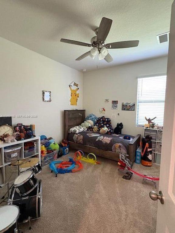 571 Old Country Rd S East Palm Bay, FL 32909 - Photo 19 of 29 a bed room with furniture and a window