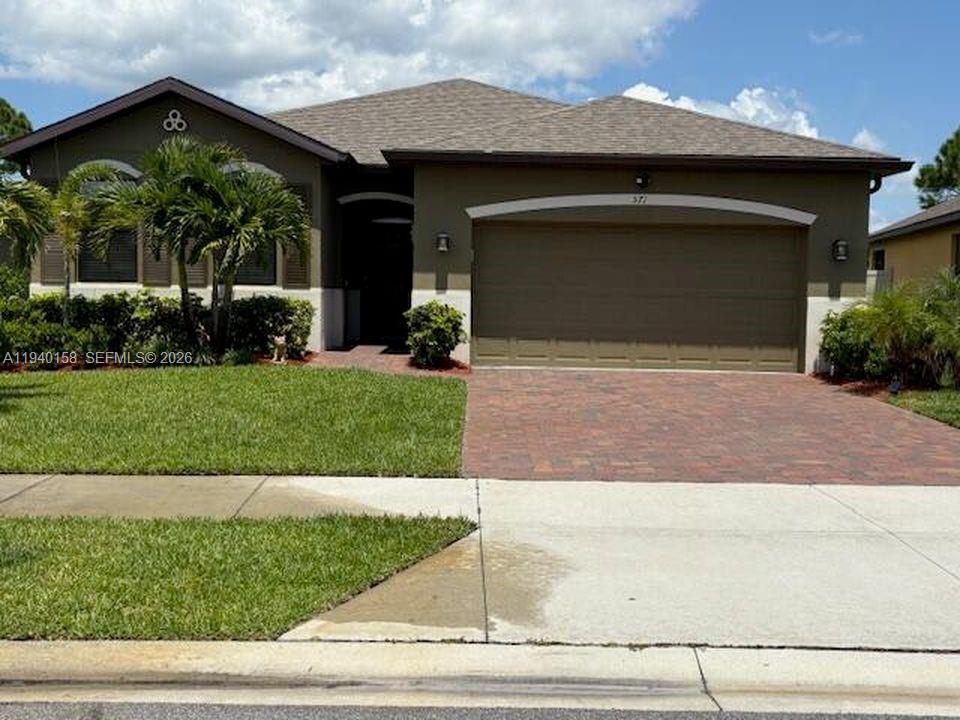 571 Old Country Rd S East Palm Bay, FL 32909 - Photo 2 of 29 a front view of a house with garage