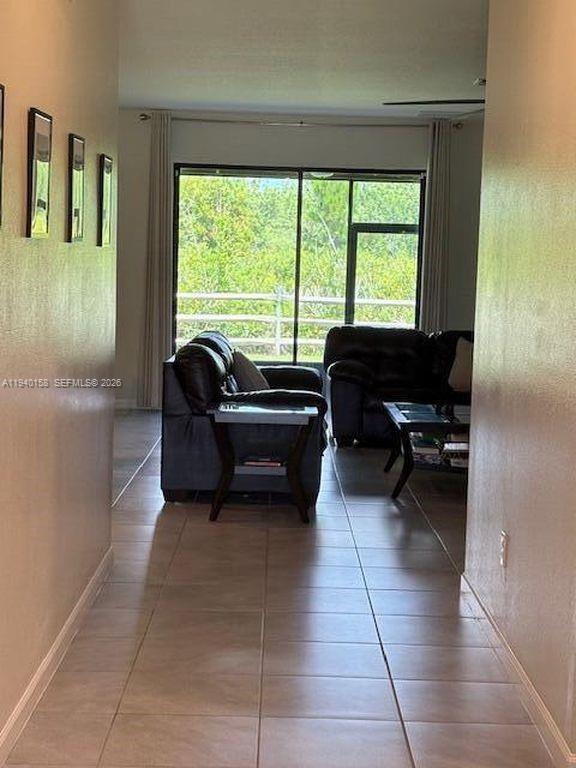 571 Old Country Rd S East Palm Bay, FL 32909 - Photo 4 of 29 a living room with furniture and a floor to ceiling window