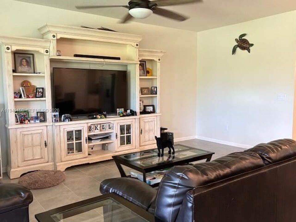 571 Old Country Rd S East Palm Bay, FL 32909 - Photo 9 of 29 a living room with furniture and a flat screen tv