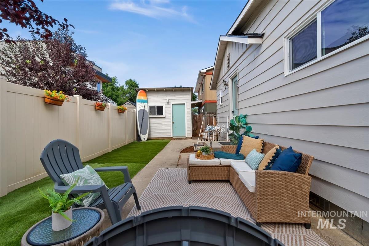 3005 West Hester Street Boise, ID 83702 - Photo 4 of 32 Private backyard featuring a paved patio, artificial turf, and a light-colored privacy fence