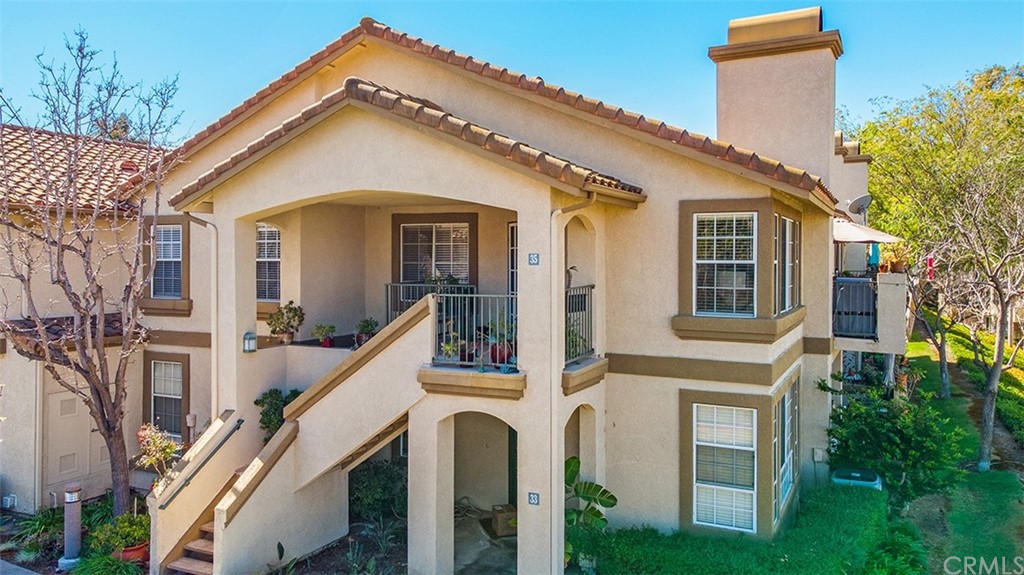 a view of a white house with a large windows and stairs