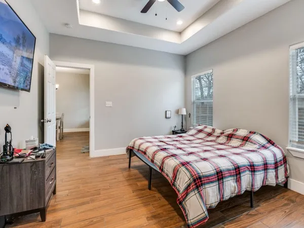 a bedroom with a bed and wooden floor