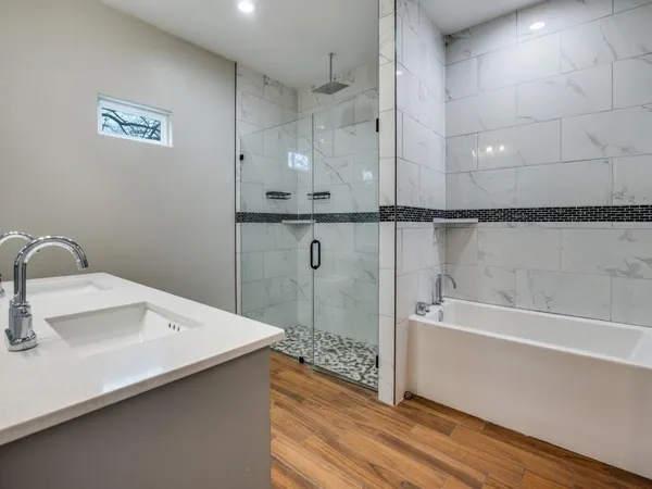 a spacious bathroom with a double vanity sink and a mirror