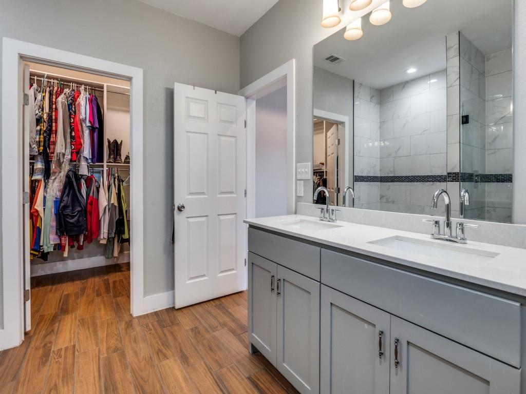 908 East Decatur Street Ennis, TX 75119 - Photo 16 of 22 a spacious bathroom with a double vanity sink and a mirror
