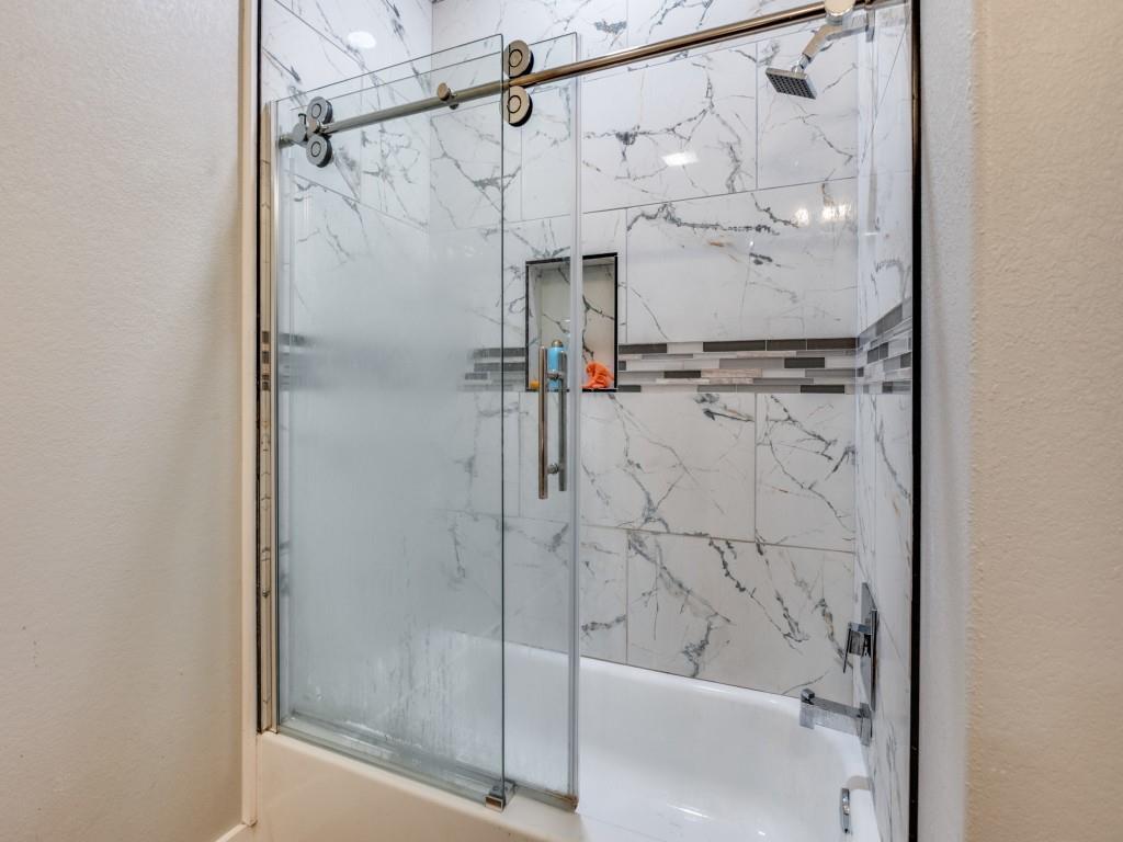 908 East Decatur Street Ennis, TX 75119 - Photo 19 of 22 a bathroom with a shower and a shower