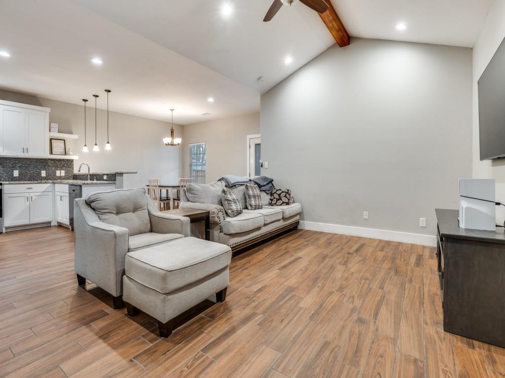 908 East Decatur Street Ennis, TX 75119 - Photo 5 of 22 a living room with couches and kitchen view with wooden floor