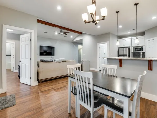 a kitchen with stainless steel appliances granite countertop a stove and a wooden floors