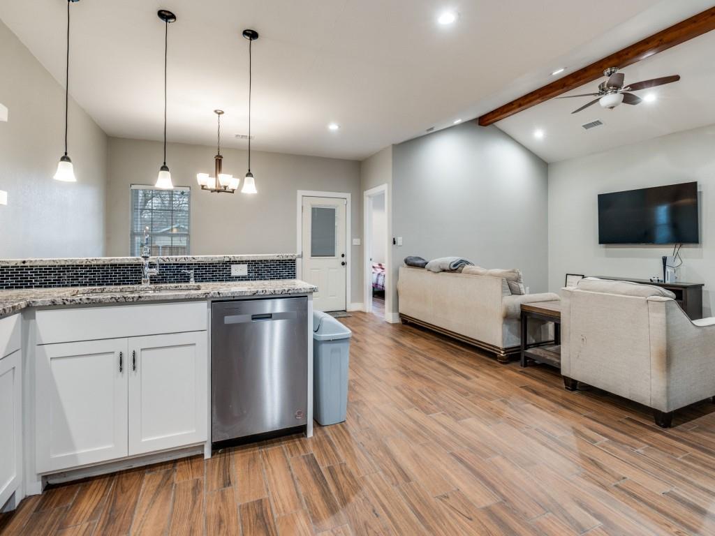 908 East Decatur Street Ennis, TX 75119 - Photo 8 of 22 a kitchen with stainless steel appliances granite countertop a stove and a wooden floors