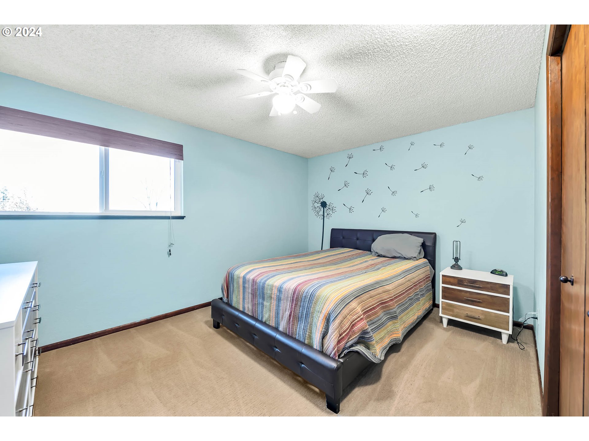 568 South 68th Place Springfield, OR 97478 - Photo 31 of 44 a spacious bedroom with a bed and a chandelier
