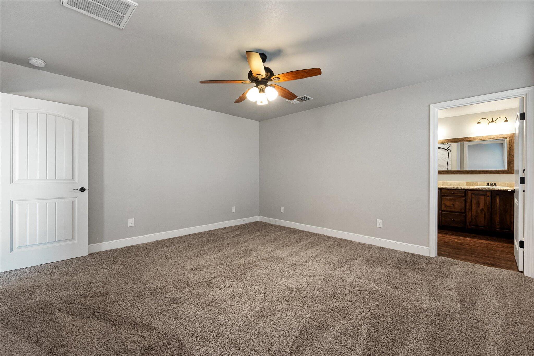 4916 Itasca Street Lubbock, TX 79416 - Photo 15 of 27 an empty room with closet and a ceiling fan