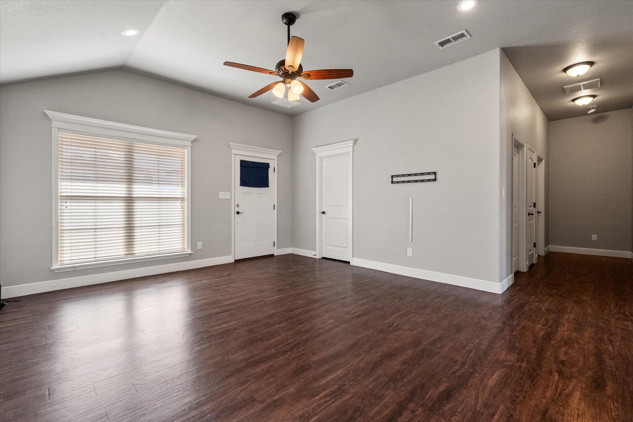 4916 Itasca Street Lubbock, TX 79416 - Photo 6 of 27 a view of an empty room with wooden floor and a window