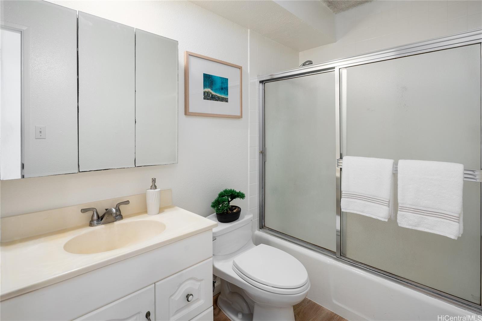 2092 Kūhiō Avenue, Unit 1003 Honolulu, HI 96815 - Photo 11 of 17 a bathroom with a sink toilet and shower