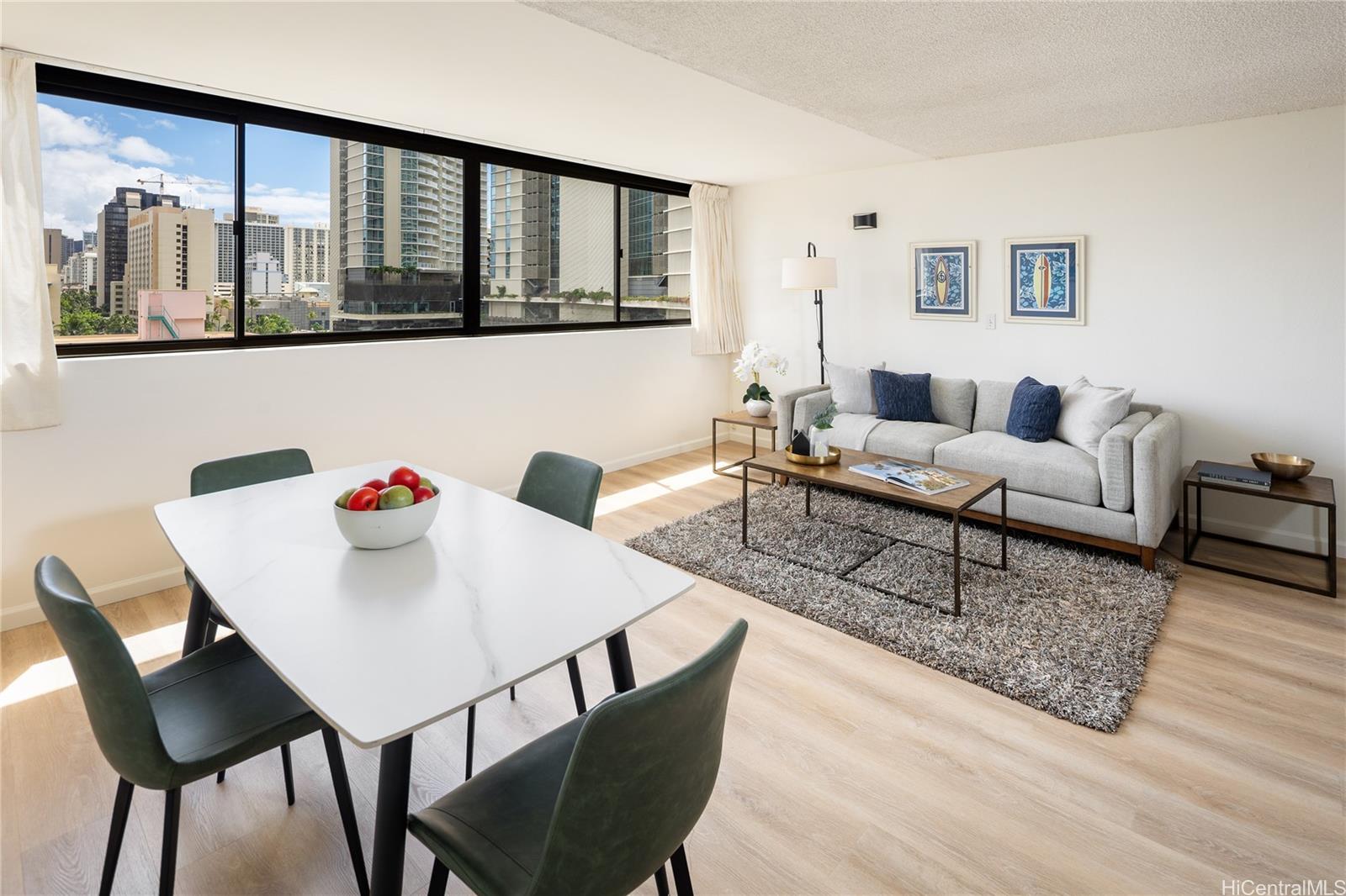 2092 Kūhiō Avenue, Unit 1003 Honolulu, HI 96815 - Photo 12 of 17 a living room with furniture and wooden floor