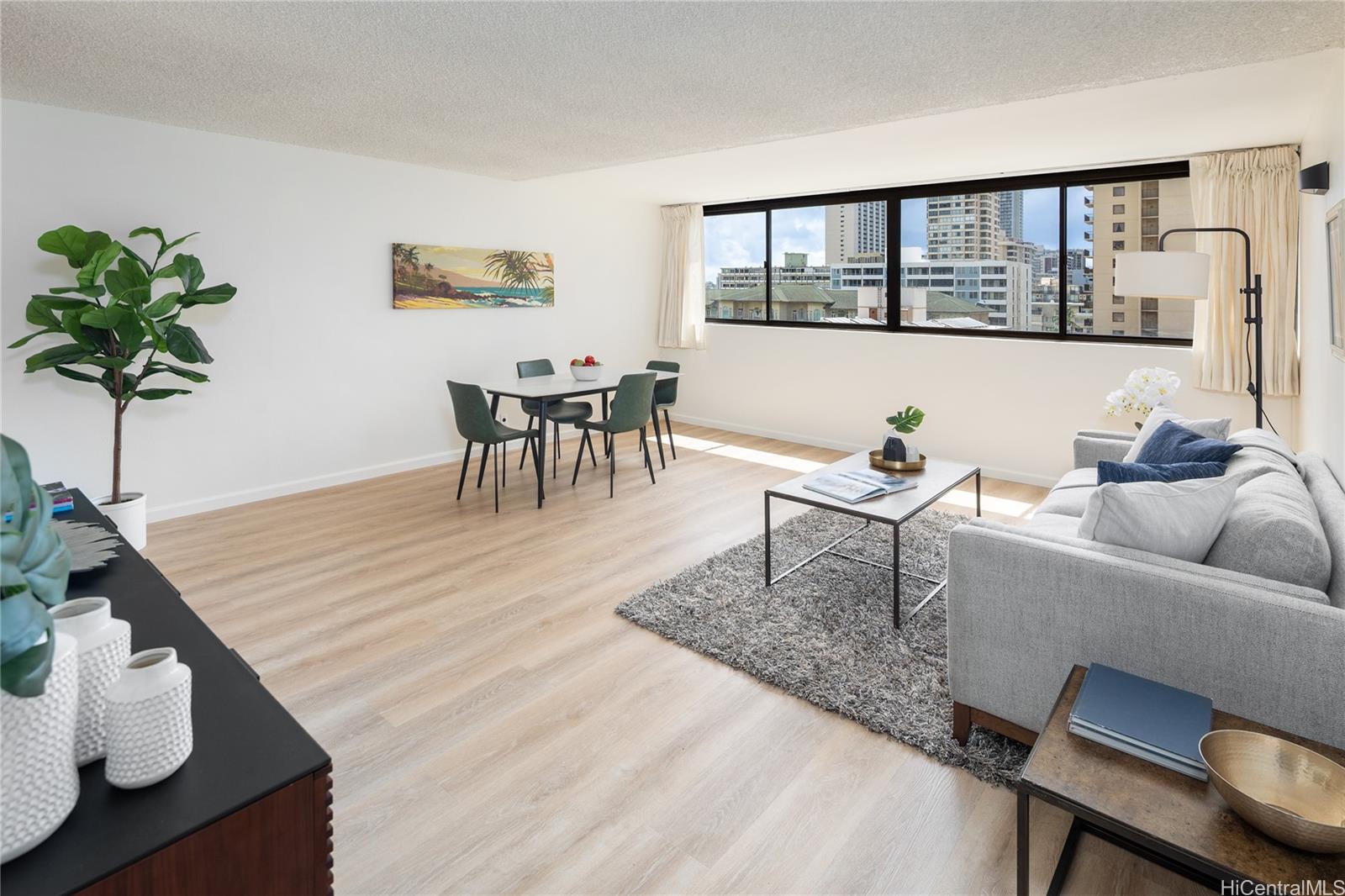 2092 Kūhiō Avenue, Unit 1003 Honolulu, HI 96815 - Photo 2 of 17 a living room with furniture and a potted plant