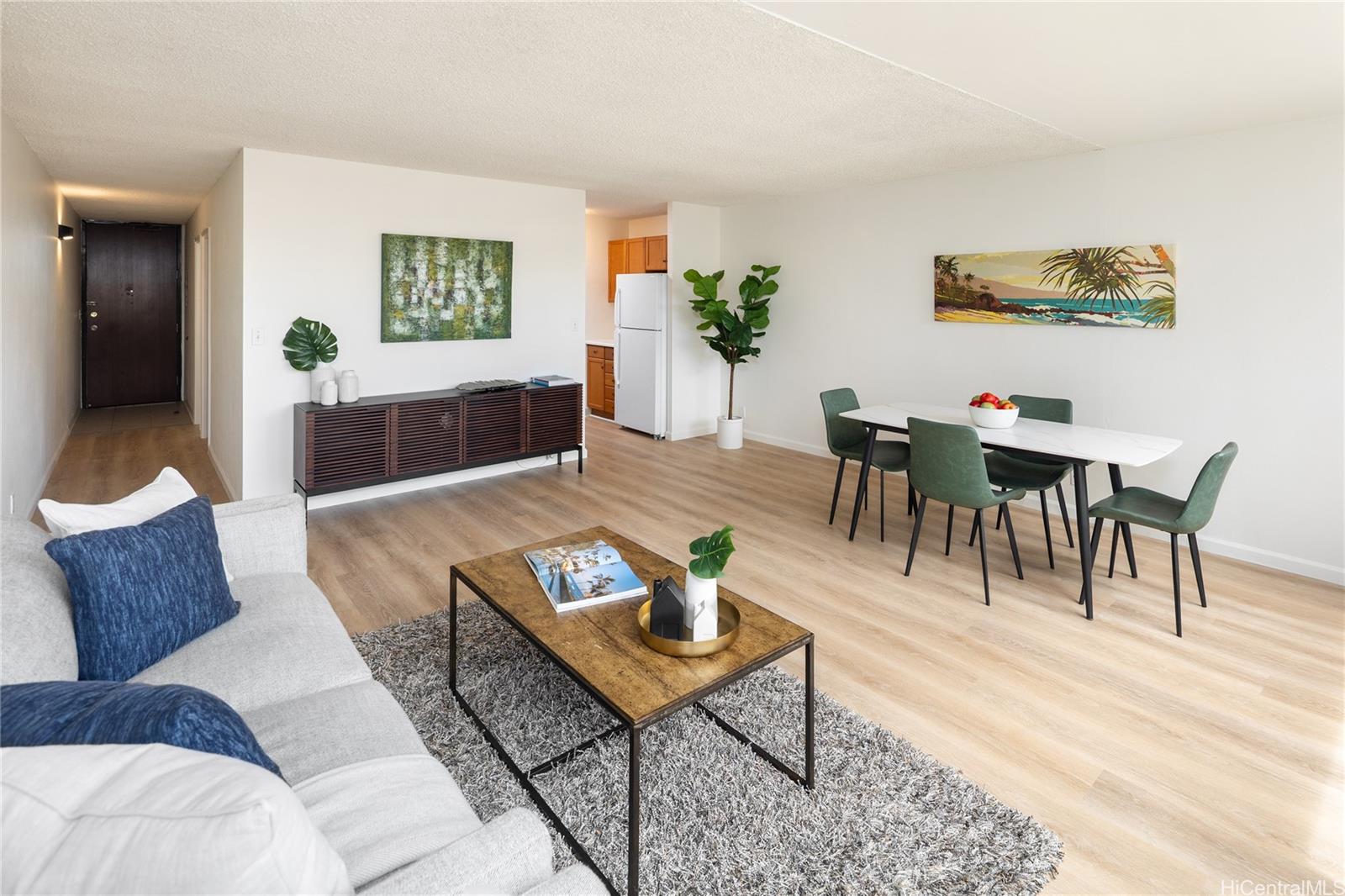 2092 Kūhiō Avenue, Unit 1003 Honolulu, HI 96815 - Photo 4 of 17 a living room with furniture and wooden floor