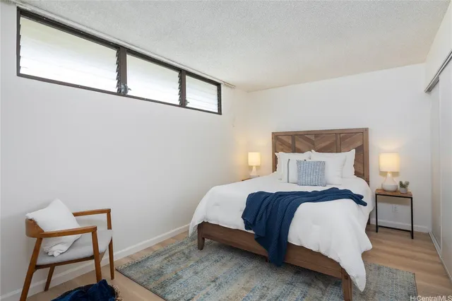 a bedroom with a bed and chair