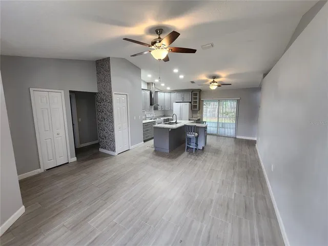 a view of a livingroom with furniture and a ceiling fan