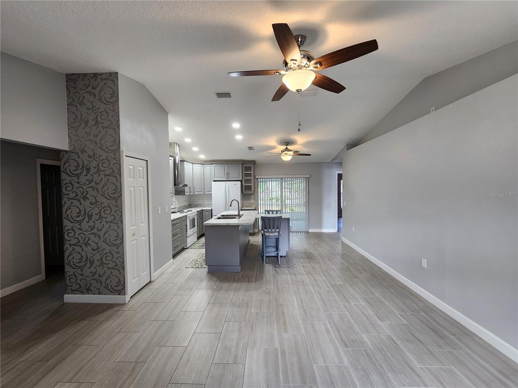 38 General Doolittle Road Daytona Beach, FL 32124 - Photo 14 of 19 a view of a livingroom with furniture and a ceiling fan