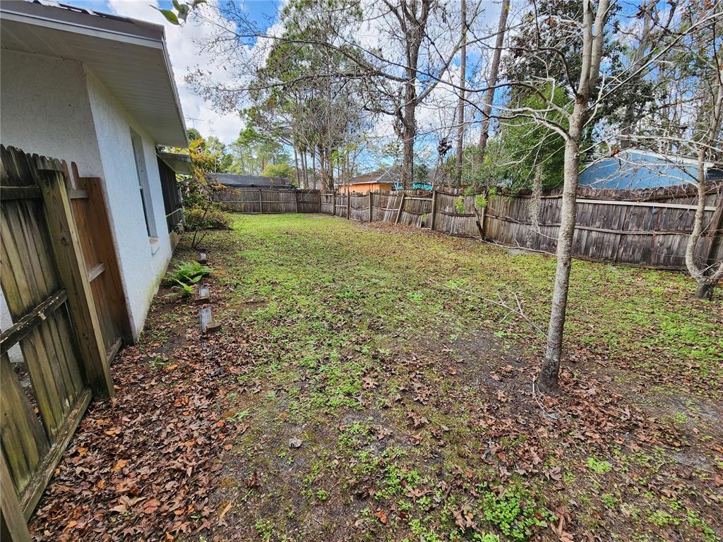38 General Doolittle Road Daytona Beach, FL 32124 - Photo 6 of 19 a view of a backyard with wooden fence