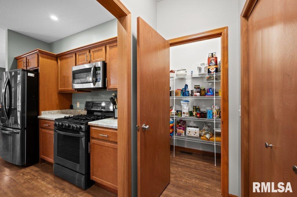 1215 Waverly Road Davenport, IA 52804 - Photo 11 of 34 a kitchen with stainless steel appliances a refrigerator and a stove top oven