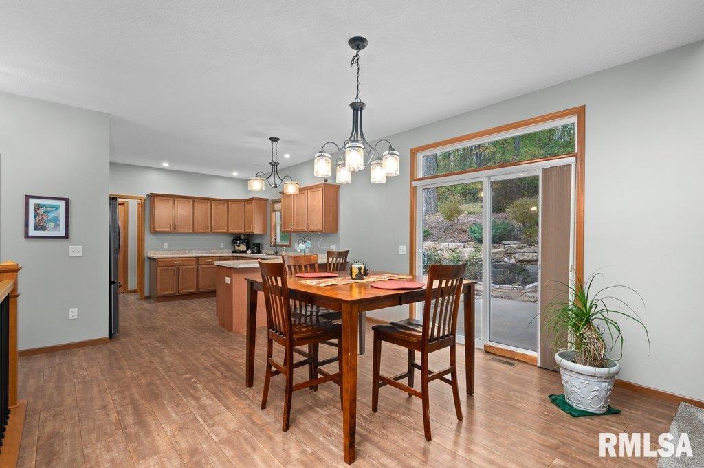 1215 Waverly Road Davenport, IA 52804 - Photo 13 of 34 a view of a dining room with furniture window and wooden floor