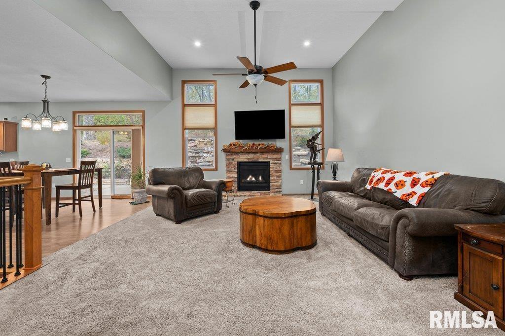 1215 Waverly Road Davenport, IA 52804 - Photo 16 of 34 a living room with furniture a flat screen tv and a fireplace