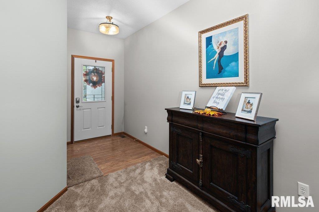 1215 Waverly Road Davenport, IA 52804 - Photo 19 of 34 a room that has a bed and paintings on the wall