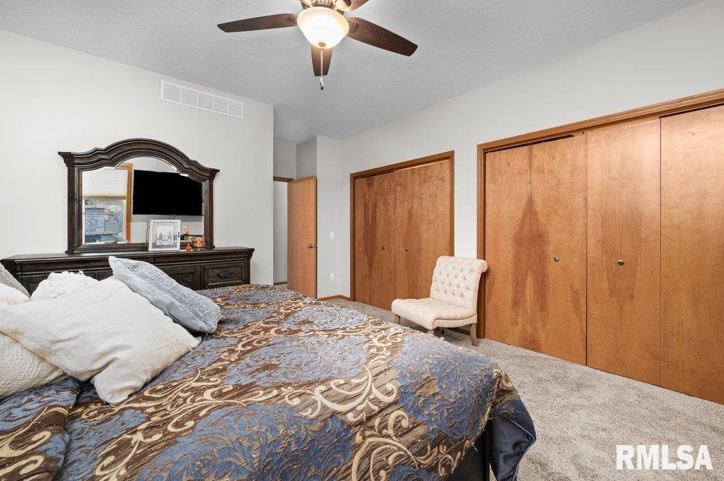 1215 Waverly Road Davenport, IA 52804 - Photo 25 of 34 a bedroom with a bed and a chandelier