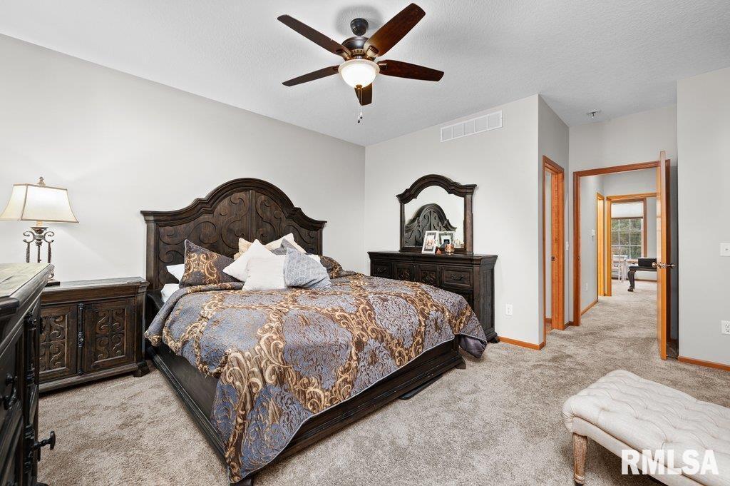 1215 Waverly Road Davenport, IA 52804 - Photo 26 of 34 a bedroom with bed and a chandelier