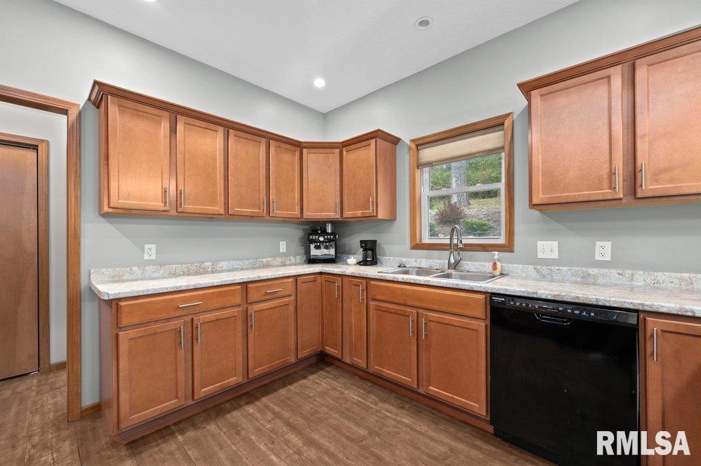 1215 Waverly Road Davenport, IA 52804 - Photo 7 of 34 a kitchen with a sink stove and cabinets