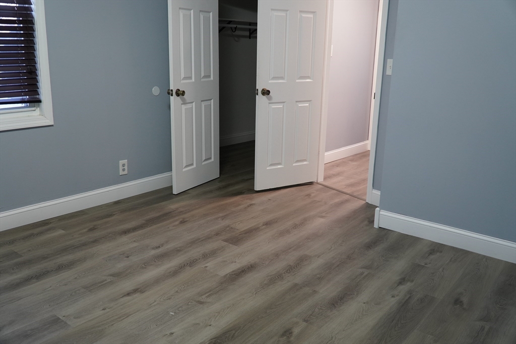 122 Norman Street West Springfield, MA 01089 - Photo 20 of 28 a view of an empty room with wooden floor and a window