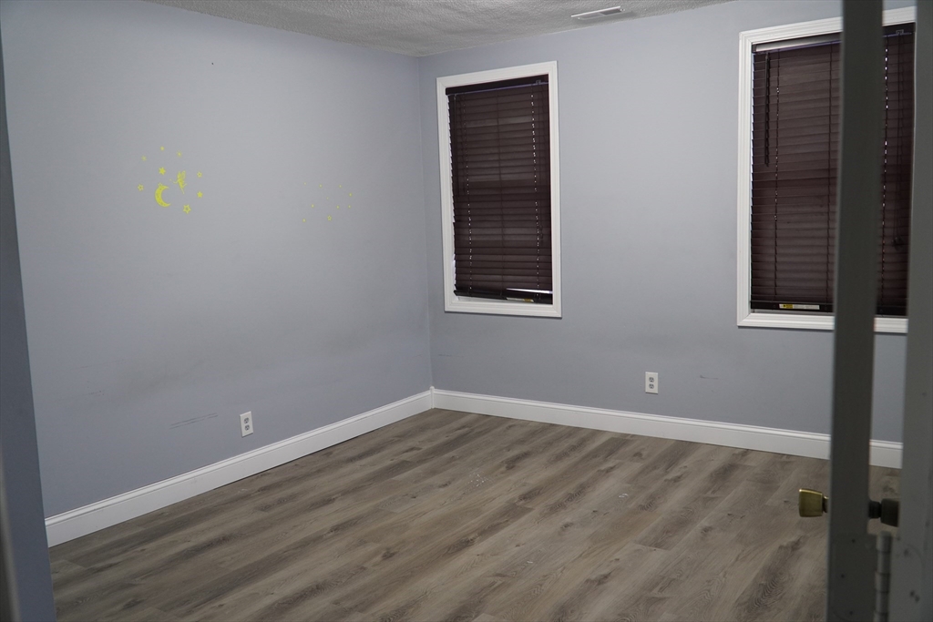 122 Norman Street West Springfield, MA 01089 - Photo 21 of 28 a view of an empty room with wooden floor and a window