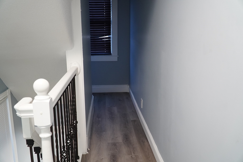 122 Norman Street West Springfield, MA 01089 - Photo 22 of 28 a view of a hallway with wooden floor and staircase