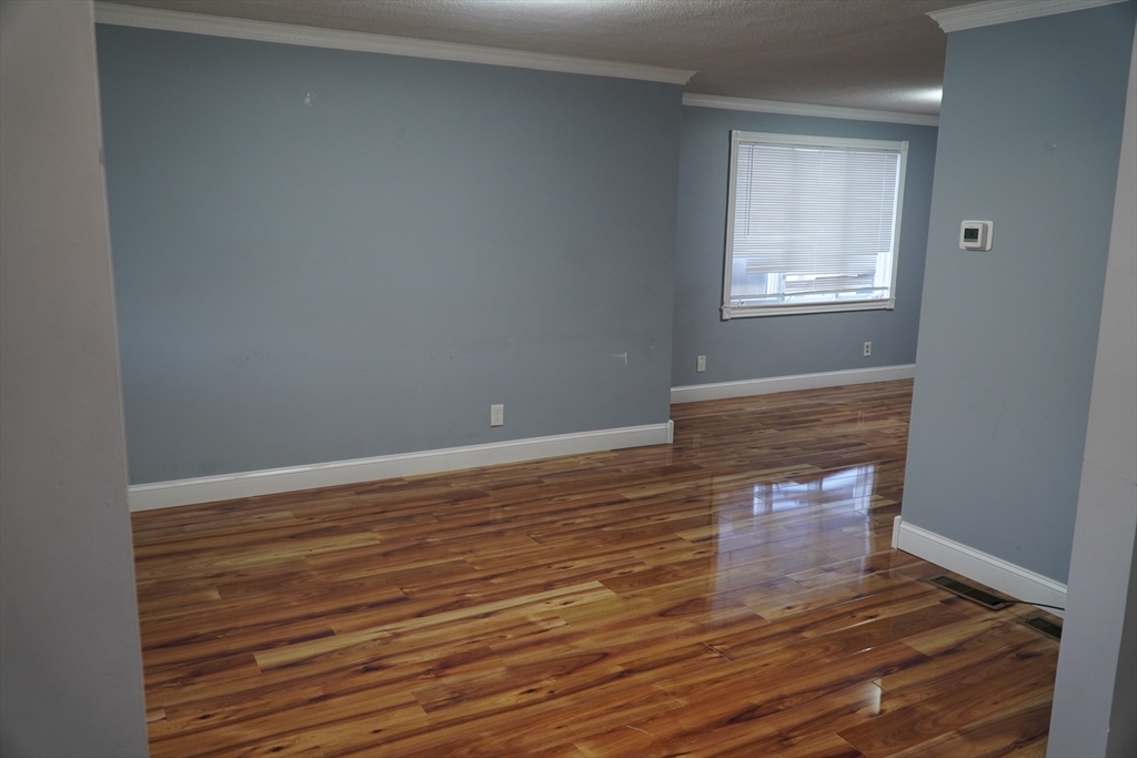 122 Norman Street West Springfield, MA 01089 - Photo 3 of 28 an empty room with wooden floor and windows