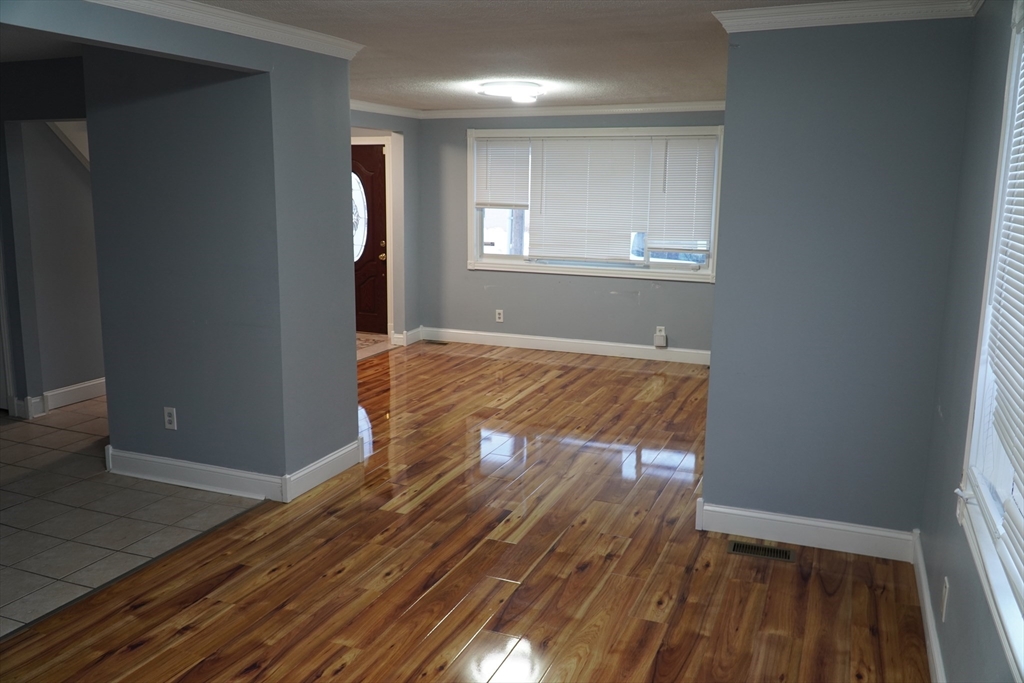 122 Norman Street West Springfield, MA 01089 - Photo 5 of 28 an empty room with wooden floor and windows