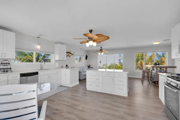 a kitchen with white cabinets and appliances