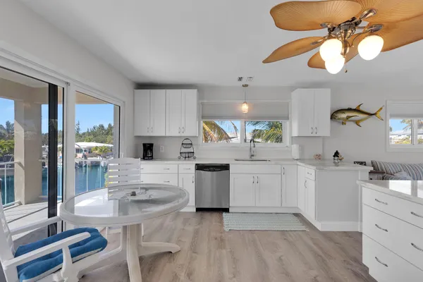 a kitchen with a sink cabinets and window